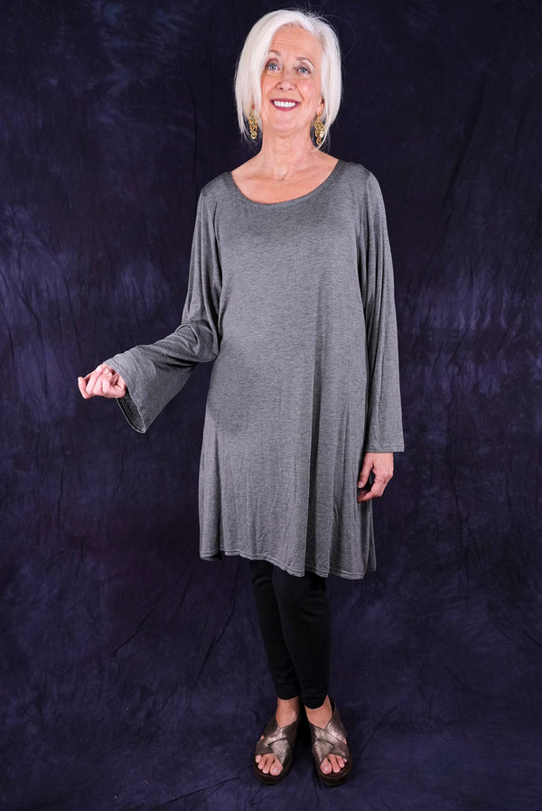 Mature woman wearing gray tunic with black leggings
